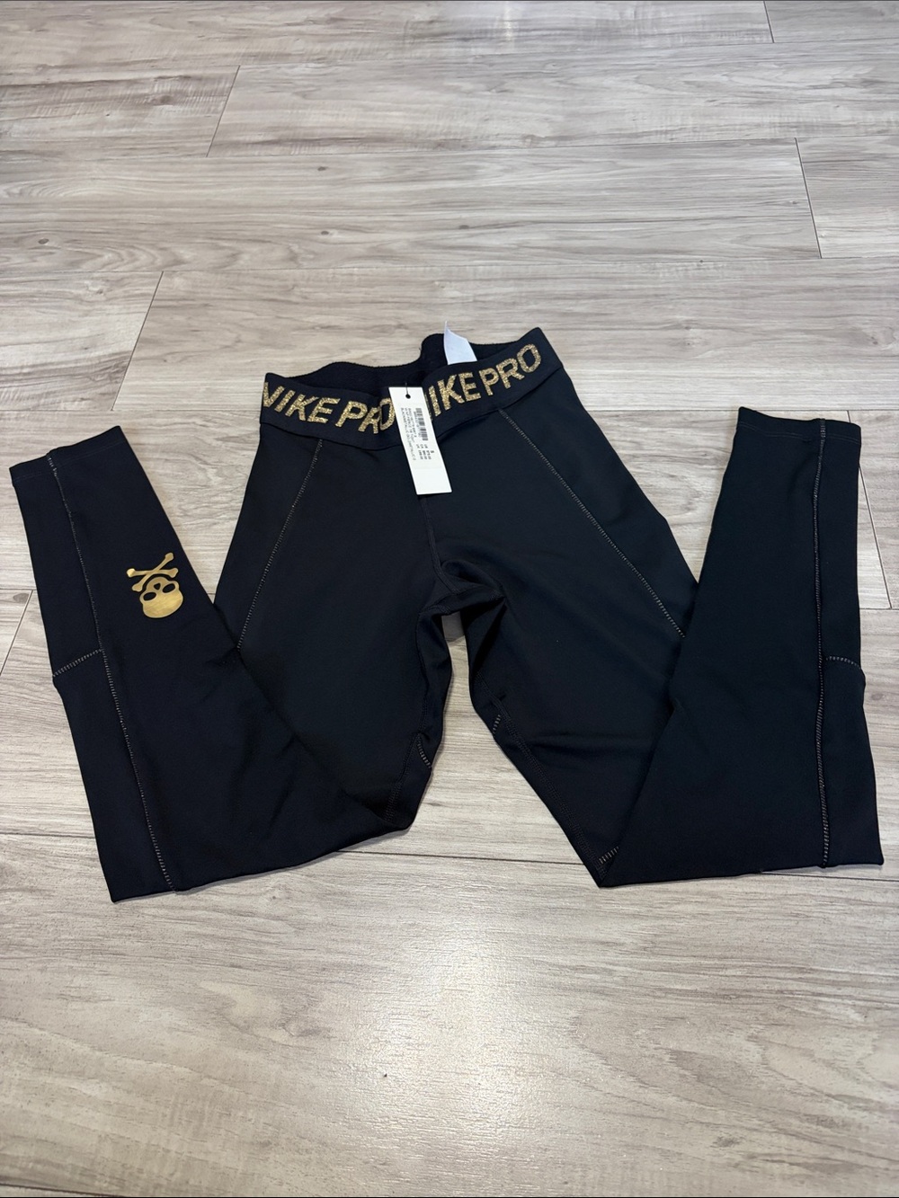 Nike Black women Performance Leggings with Gold Skull Accent